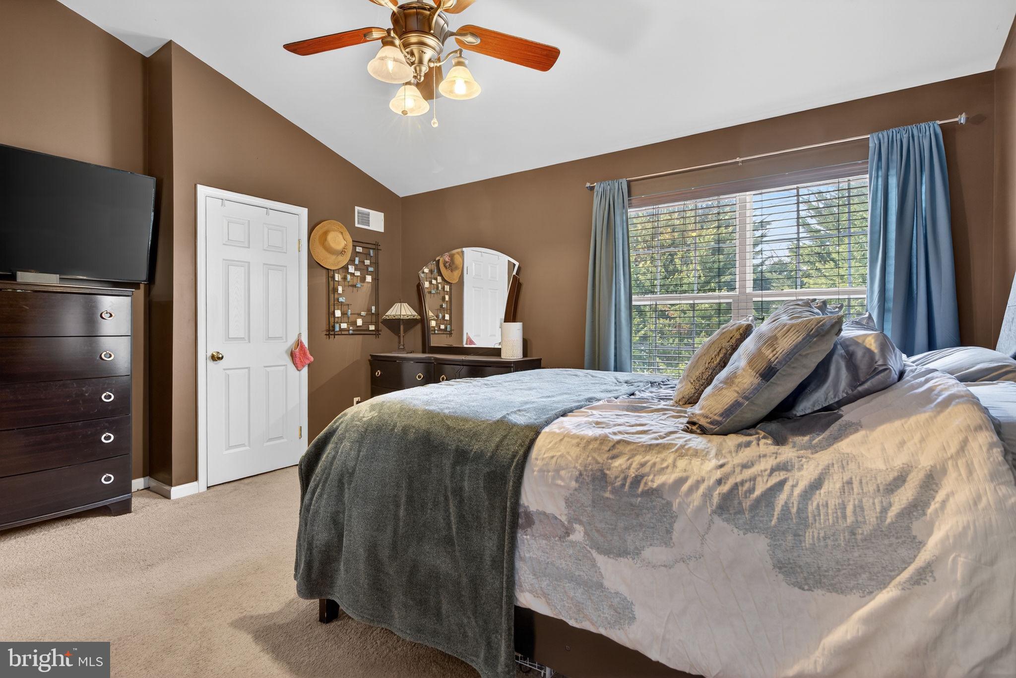 2436 Schultz Way, Unit 19 York, PA 17402 - Photo 18 of 30 a bedroom with a bed and a chandelier