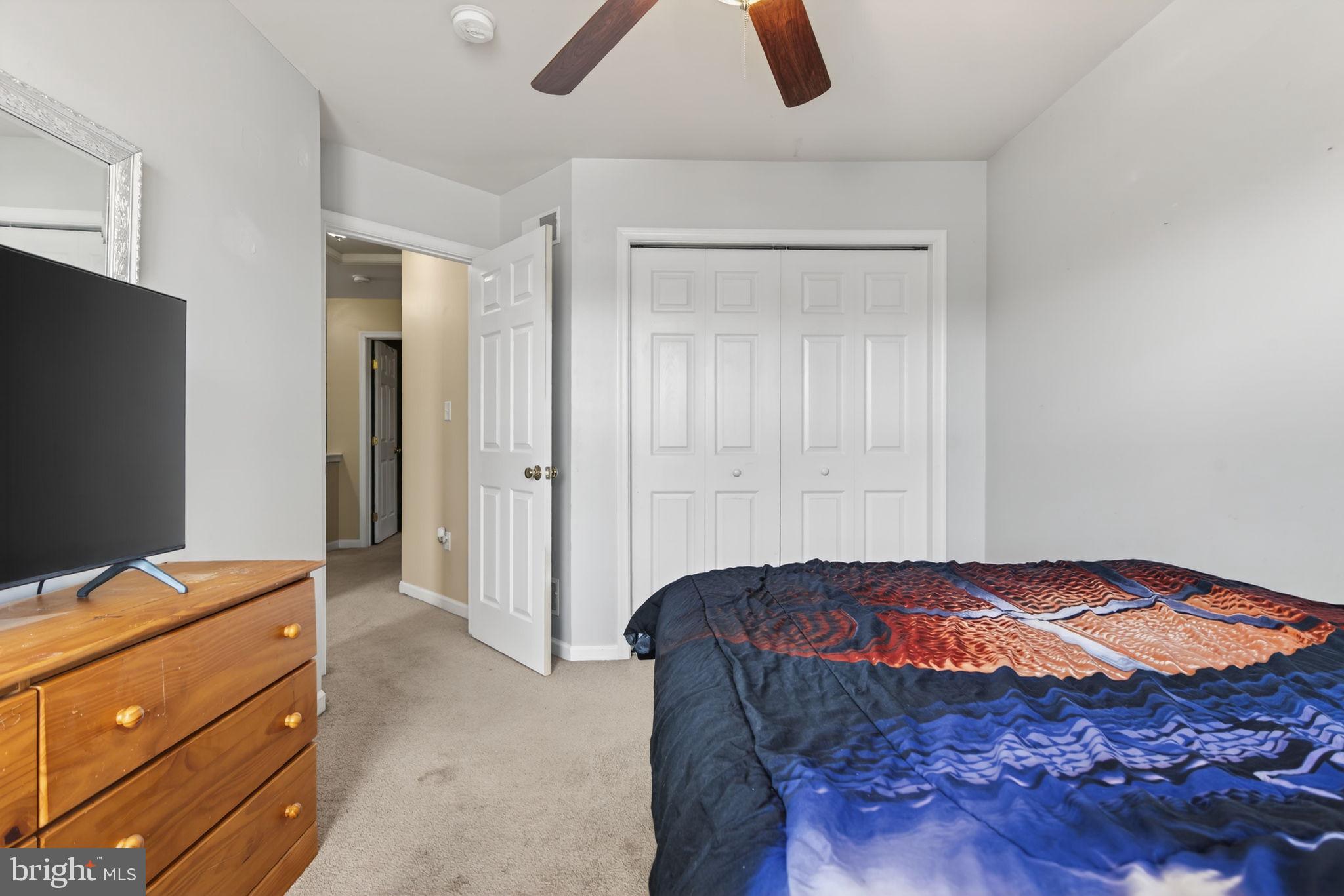2436 Schultz Way, Unit 19 York, PA 17402 - Photo 23 of 30 a bedroom with a bed and a flat tv screen on the dresser