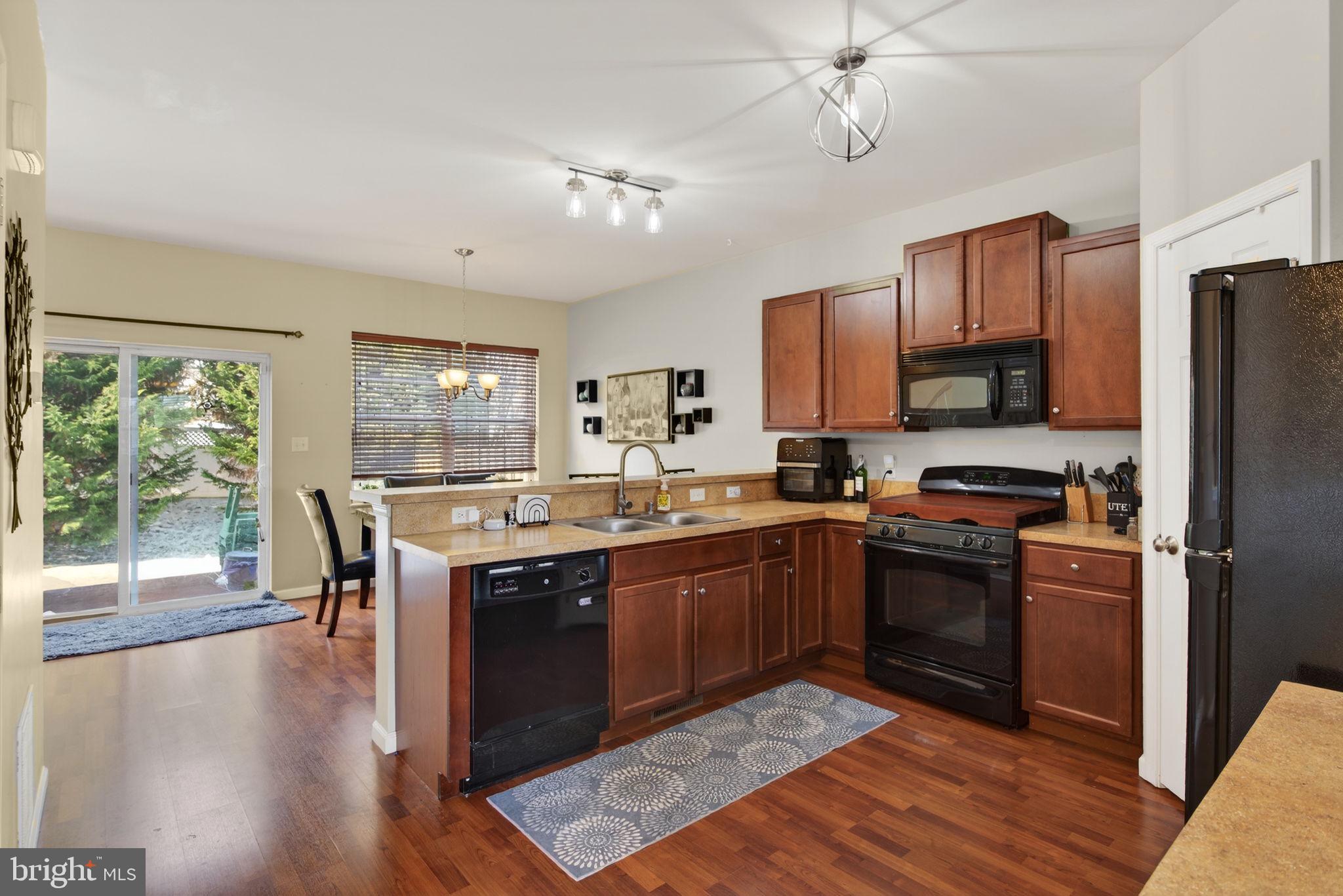 2436 Schultz Way, Unit 19 York, PA 17402 - Photo 6 of 30 a large kitchen with stainless steel appliances granite countertop a stove refrigerator and a view of living room