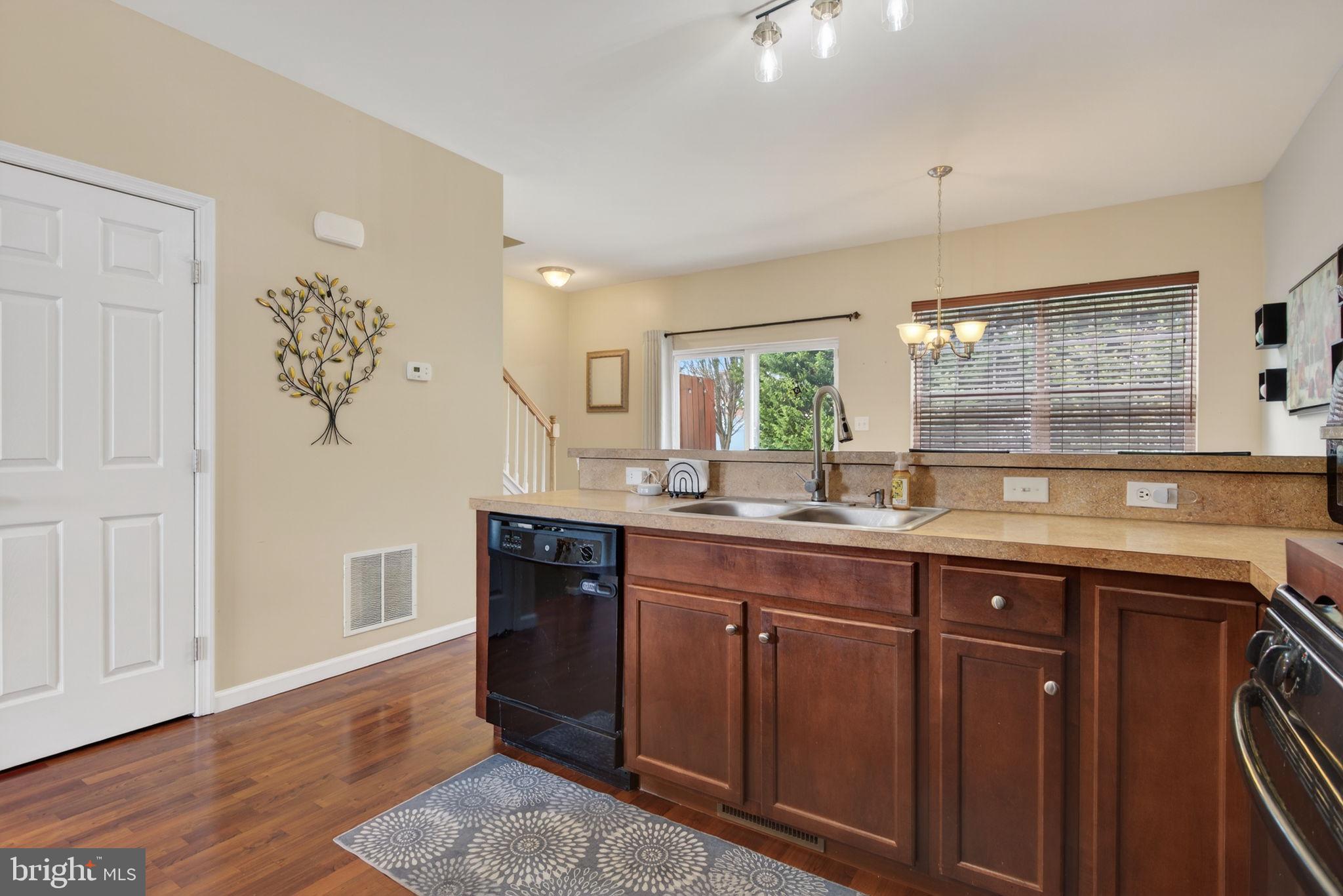 2436 Schultz Way, Unit 19 York, PA 17402 - Photo 8 of 30 a kitchen with granite countertop a sink cabinets and wooden floor