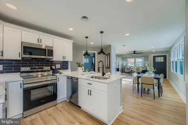 a kitchen with a sink stove and cabinets