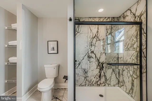 a bathroom with a toilet and a shower