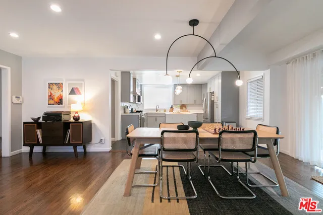 a kitchen with granite countertop a sink stove and cabinets