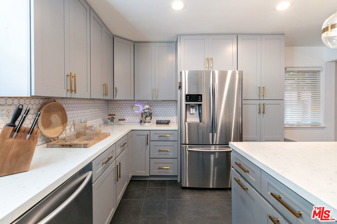 2415 8th Avenue Los Angeles, CA 90018 - Photo 18 of 55 a kitchen with a refrigerator sink and cabinets