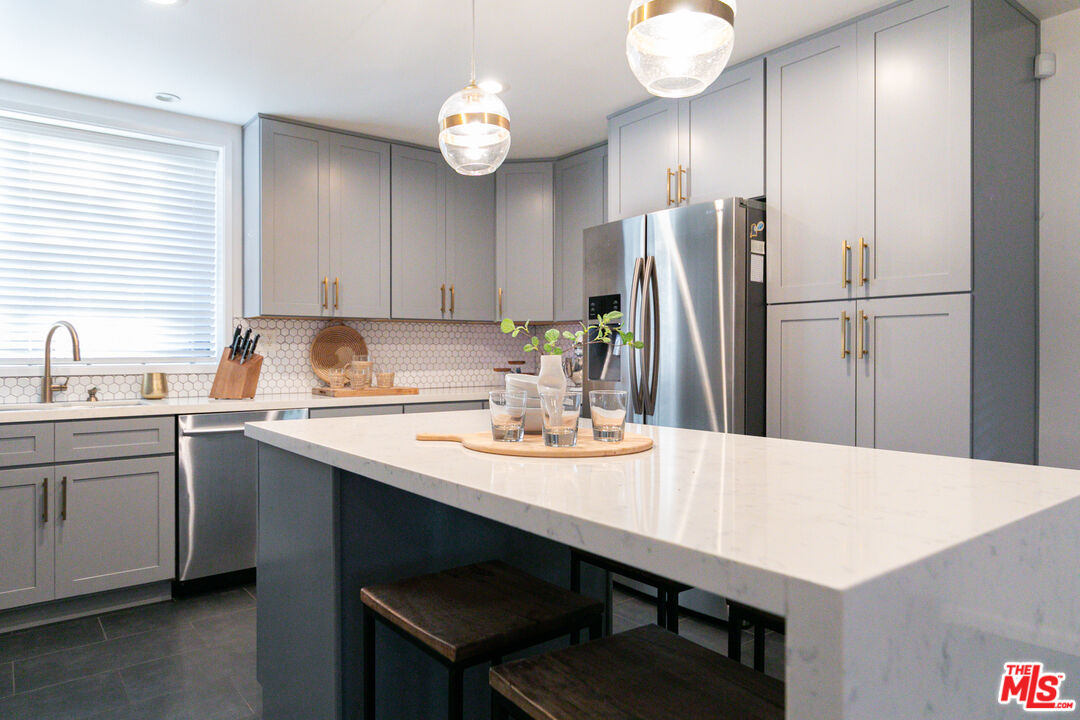 2415 8th Avenue Los Angeles, CA 90018 - Photo 19 of 55 a kitchen with a table and chairs in it