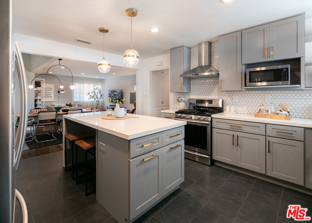 2415 8th Avenue Los Angeles, CA 90018 - Photo 20 of 55 a kitchen with a sink stove and microwave