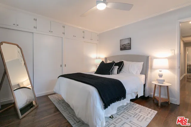 a bedroom with a bed and a painting on the wall