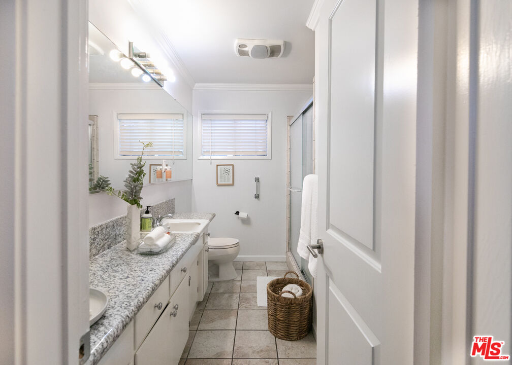 2415 8th Avenue Los Angeles, CA 90018 - Photo 33 of 55 a bathroom with a granite countertop sink and a mirror