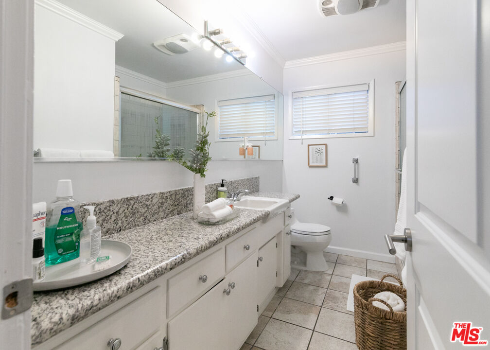 2415 8th Avenue Los Angeles, CA 90018 - Photo 34 of 55 a bathroom with a granite countertop sink and a mirror
