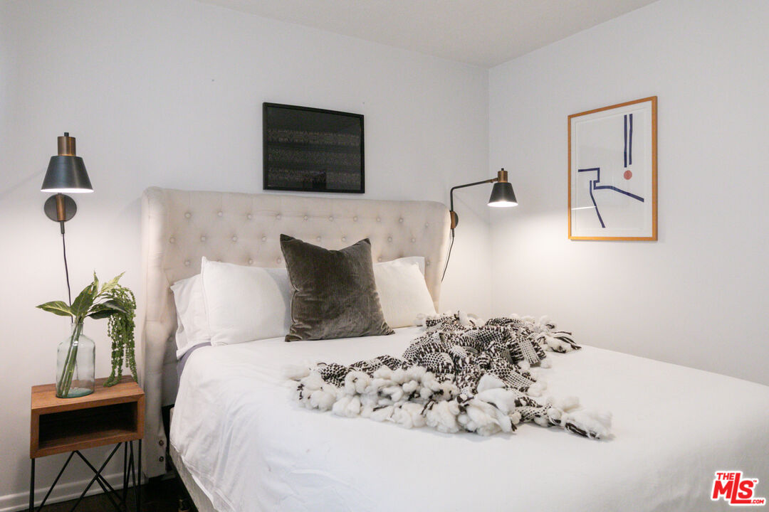 2415 8th Avenue Los Angeles, CA 90018 - Photo 39 of 55 a bedroom with a bed and a painting on the wall