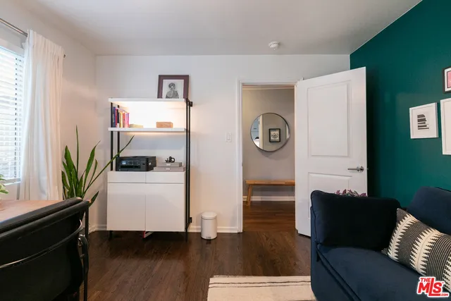 a patio with glass top table and chairs