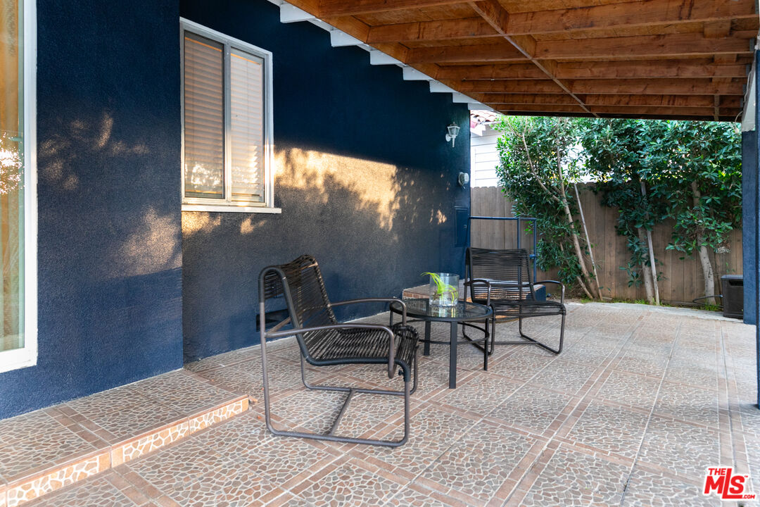 2415 8th Avenue Los Angeles, CA 90018 - Photo 48 of 55 a patio with glass top table and chairs