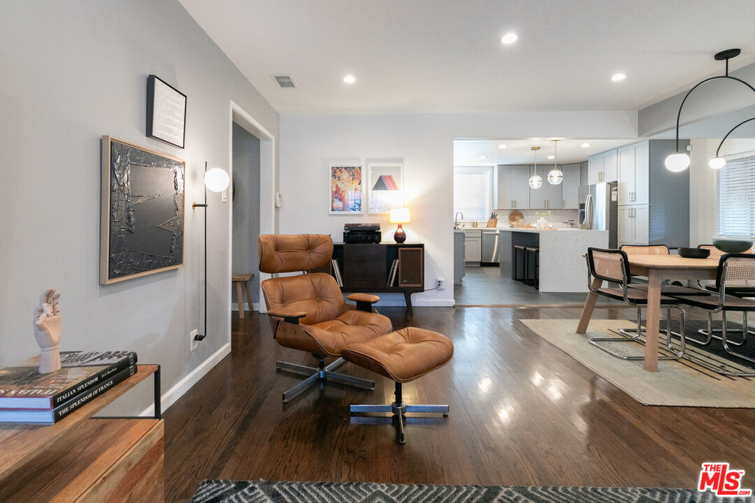 2415 8th Avenue Los Angeles, CA 90018 - Photo 10 of 55 a living room with furniture a wooden floor and next to a window