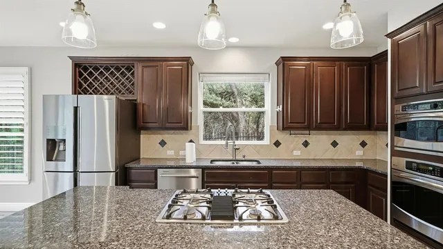a kitchen with sink refrigerator and microwave