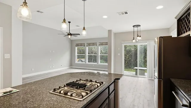 a kitchen with a stove a refrigerator and a sink