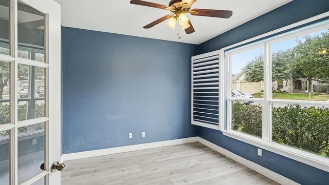 wooden floor in an empty room with a window