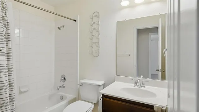 a bathroom with a sink toilet tub and shower