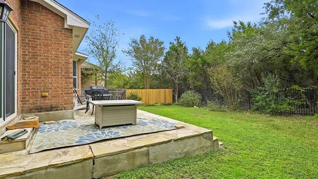 a view of a backyard with sitting area