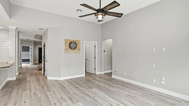 a view of an empty room with wooden floor