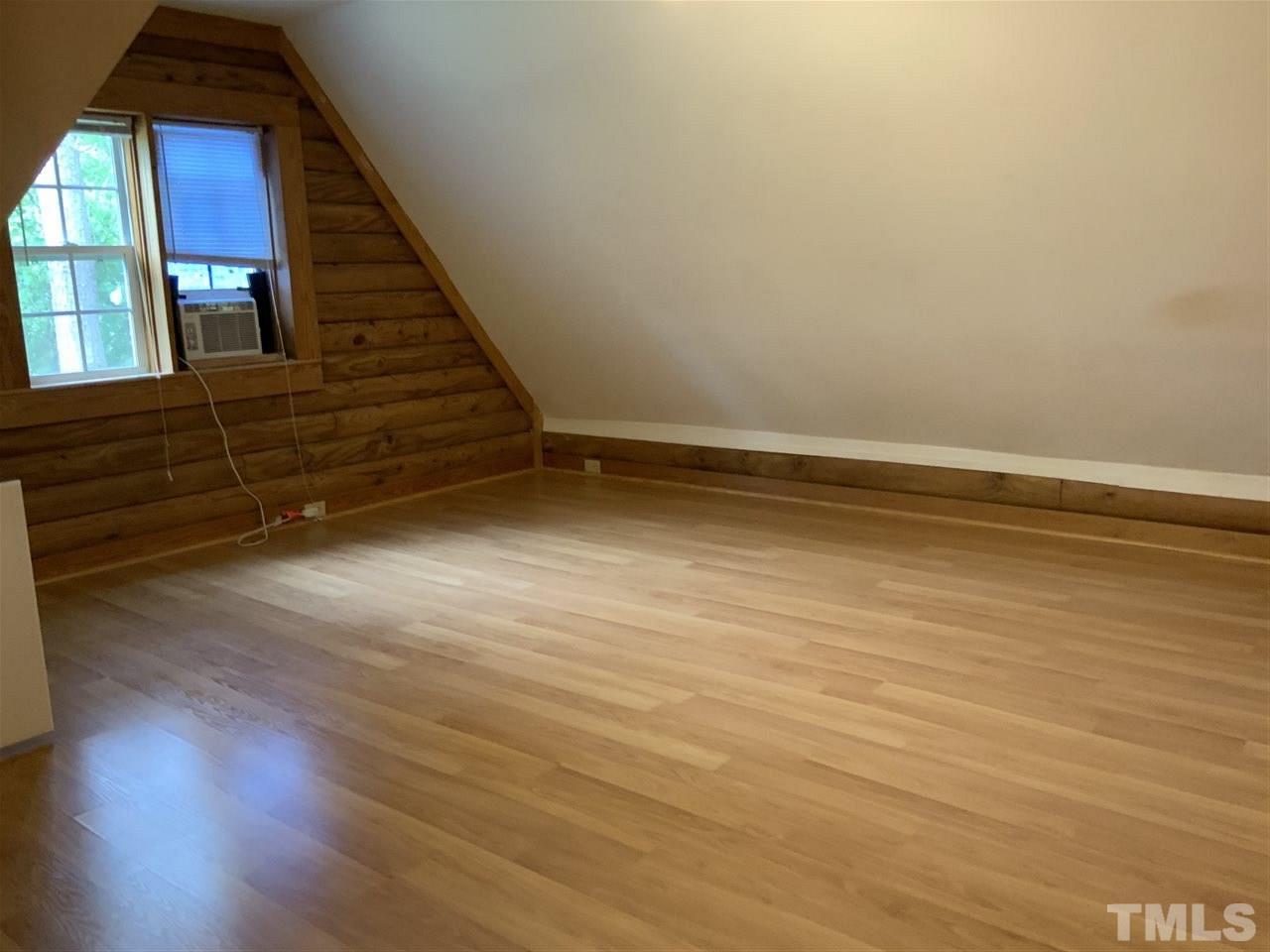 4 Dawn Road Benson, NC 27504 - Photo 12 of 19 a view of an empty room with wooden floor and a window