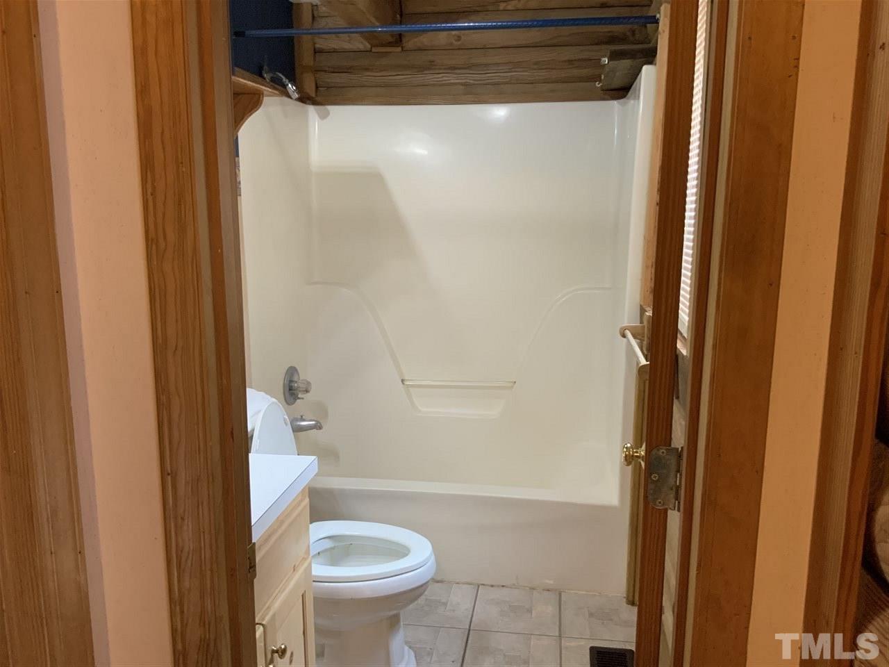 4 Dawn Road Benson, NC 27504 - Photo 15 of 19 a bathroom with a shower and a toilet