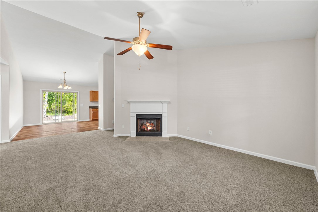 113 Crofton Court Easley, SC 29642 - Photo 4 of 33 This inviting living space features a cozy fireplace, perfect for gathering, with an open flow to the dining area.