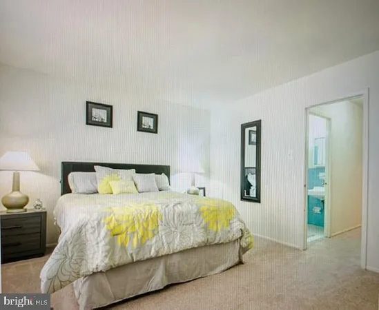 a bedroom with a bed and painting on the wall