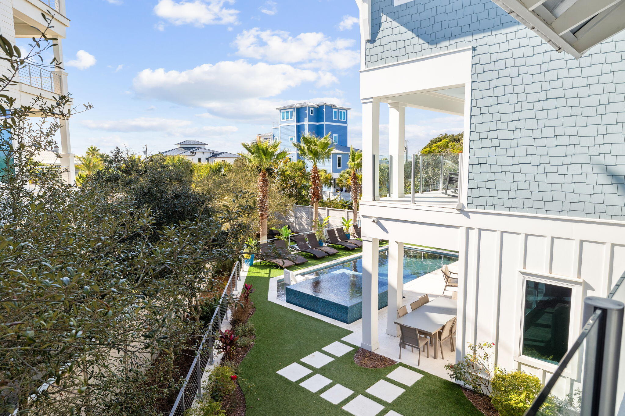 230 Blue Lake Road Santa Rosa Beach, FL 32459 - Photo 11 of 110 a balcony with table and chairs and potted plants