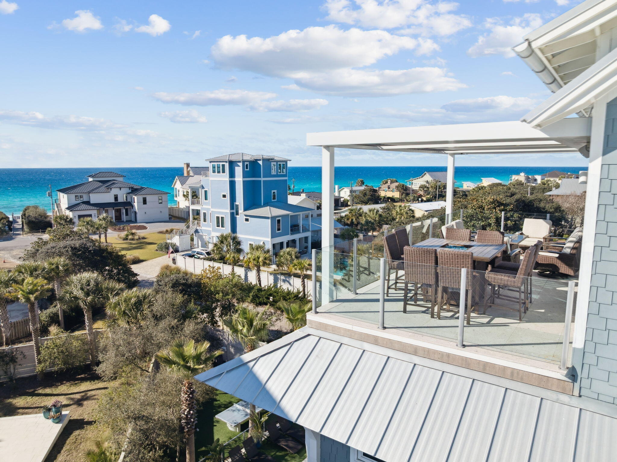 230 Blue Lake Road Santa Rosa Beach, FL 32459 - Photo 17 of 110 a view of a patio with dining table and chairs