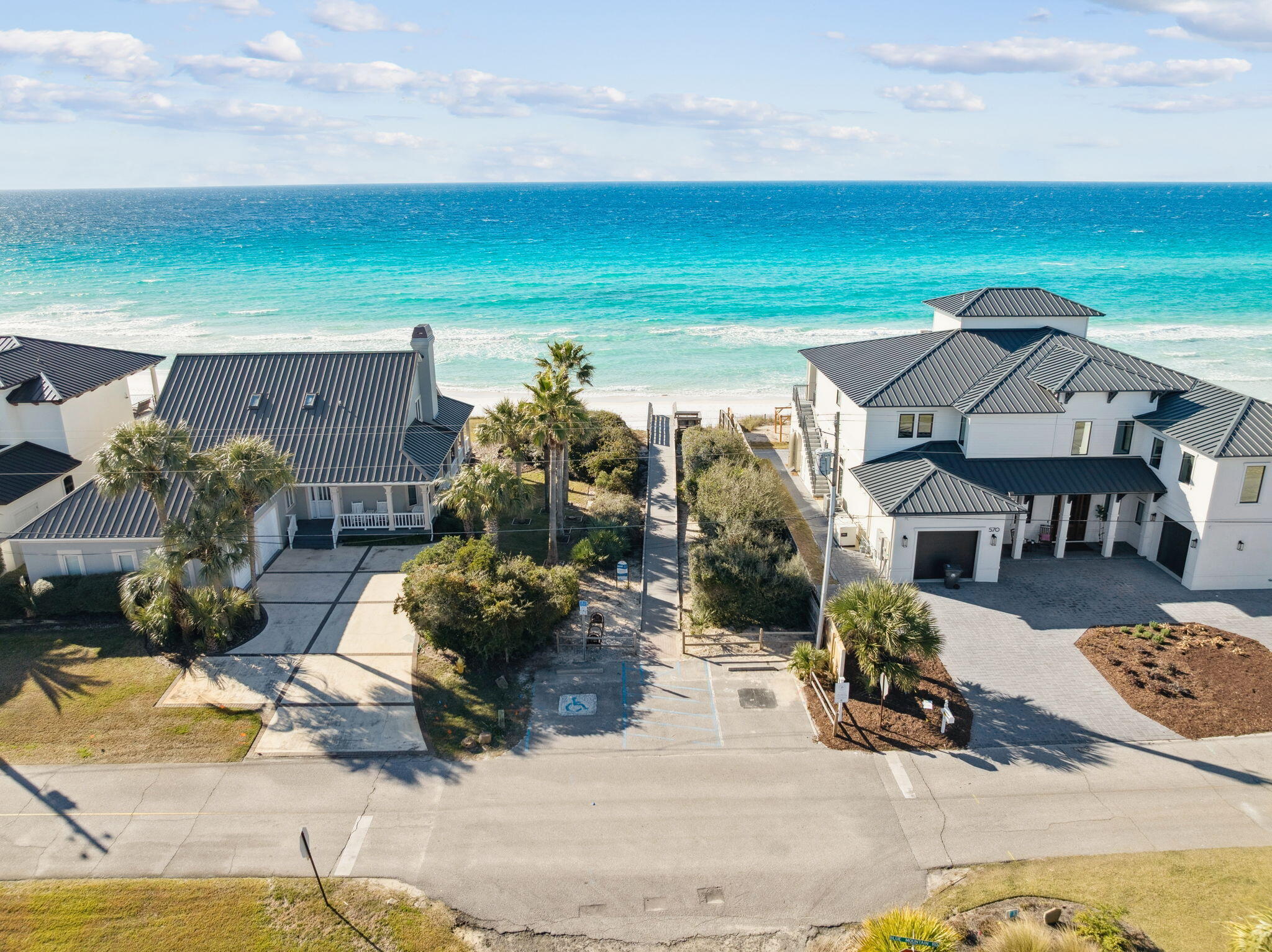 230 Blue Lake Road Santa Rosa Beach, FL 32459 - Photo 19 of 110 a roof deck with table and chairs under an umbrella