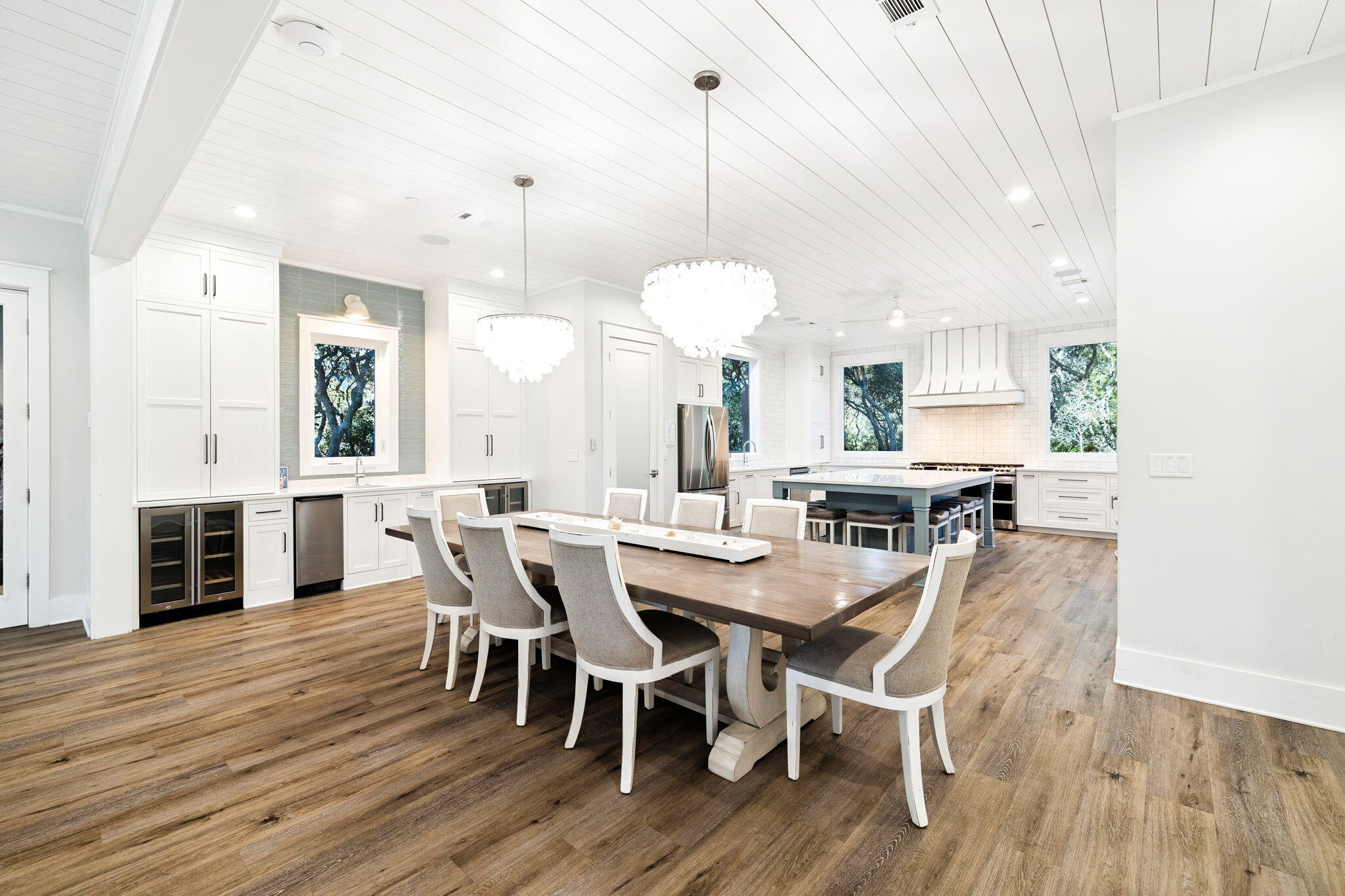 230 Blue Lake Road Santa Rosa Beach, FL 32459 - Photo 33 of 110 a view of a dining room and livingroom with furniture wooden floor a chandelier