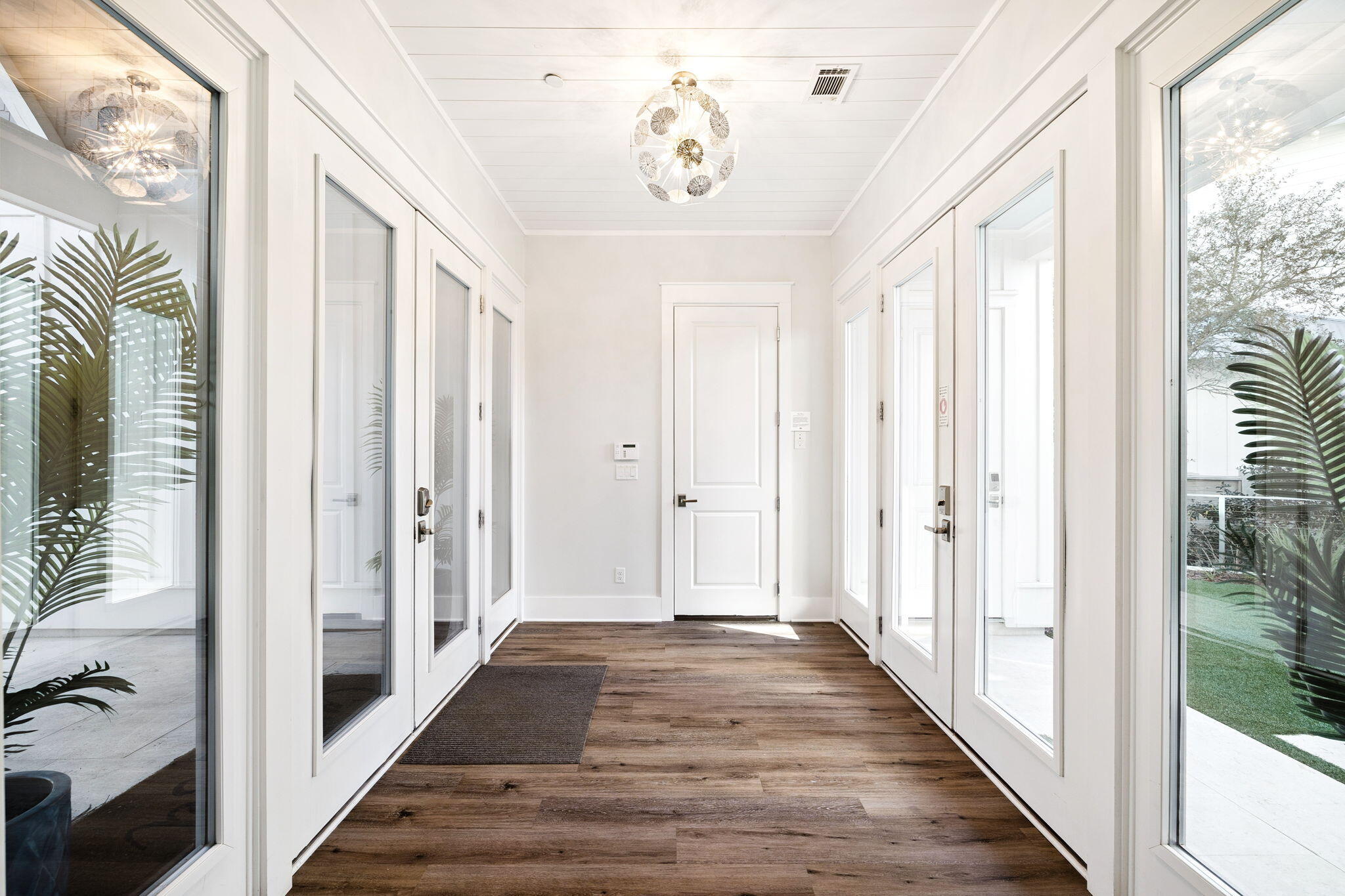 230 Blue Lake Road Santa Rosa Beach, FL 32459 - Photo 37 of 110 a view of a hallway with wooden floor and staircase