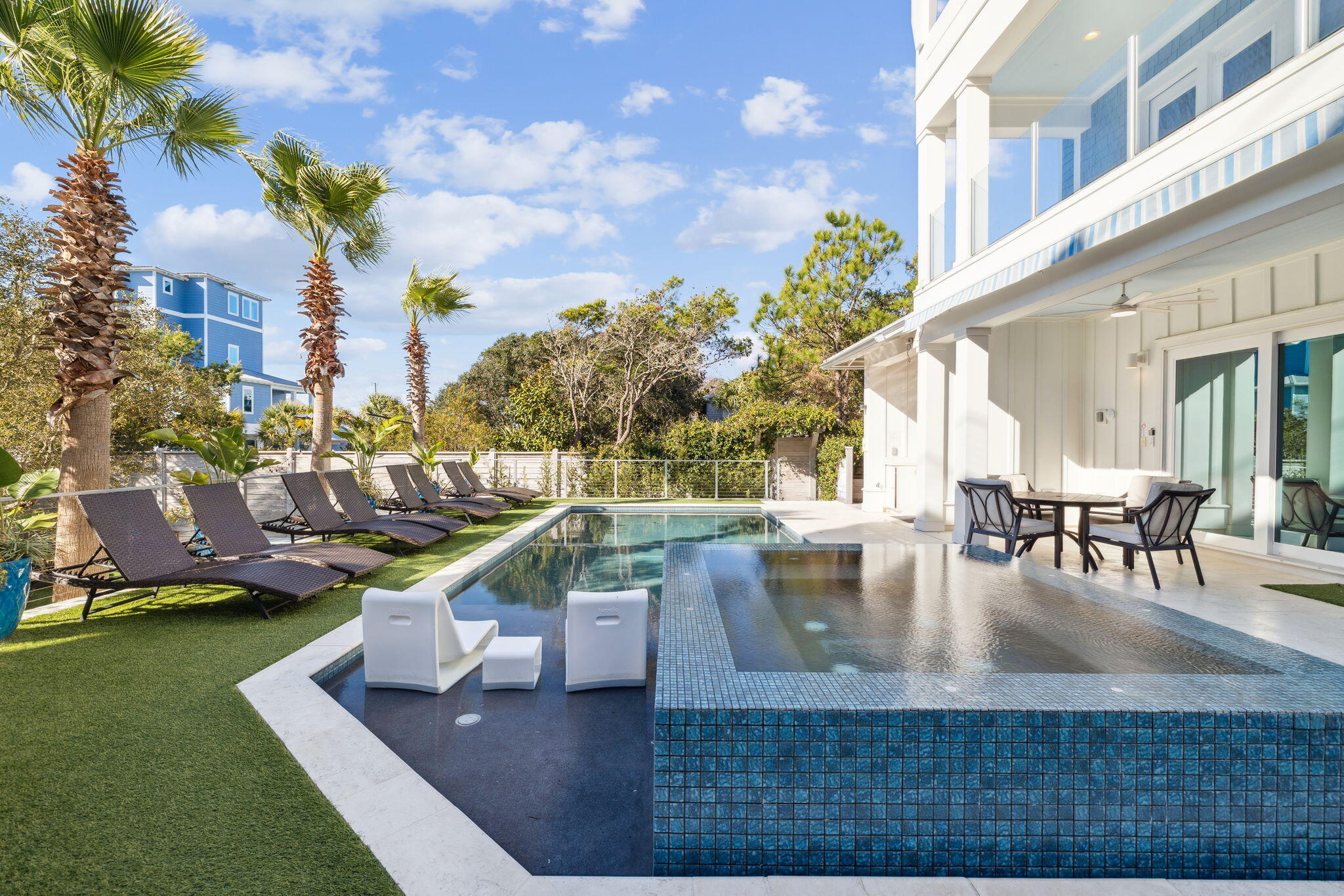 230 Blue Lake Road Santa Rosa Beach, FL 32459 - Photo 44 of 110 a view of a swimming pool with outdoor seating and plants