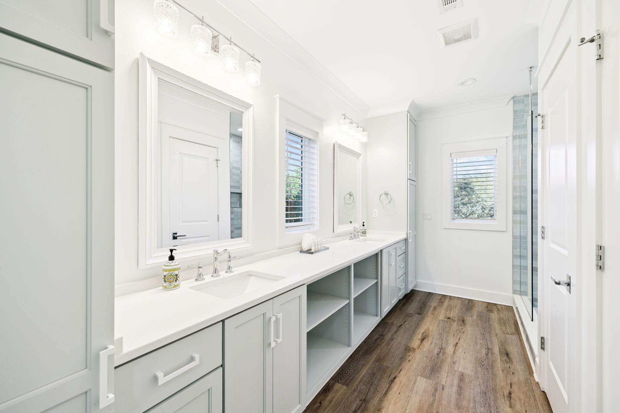230 Blue Lake Road Santa Rosa Beach, FL 32459 - Photo 59 of 110 a bathroom with a double vanity sink and mirror with shower