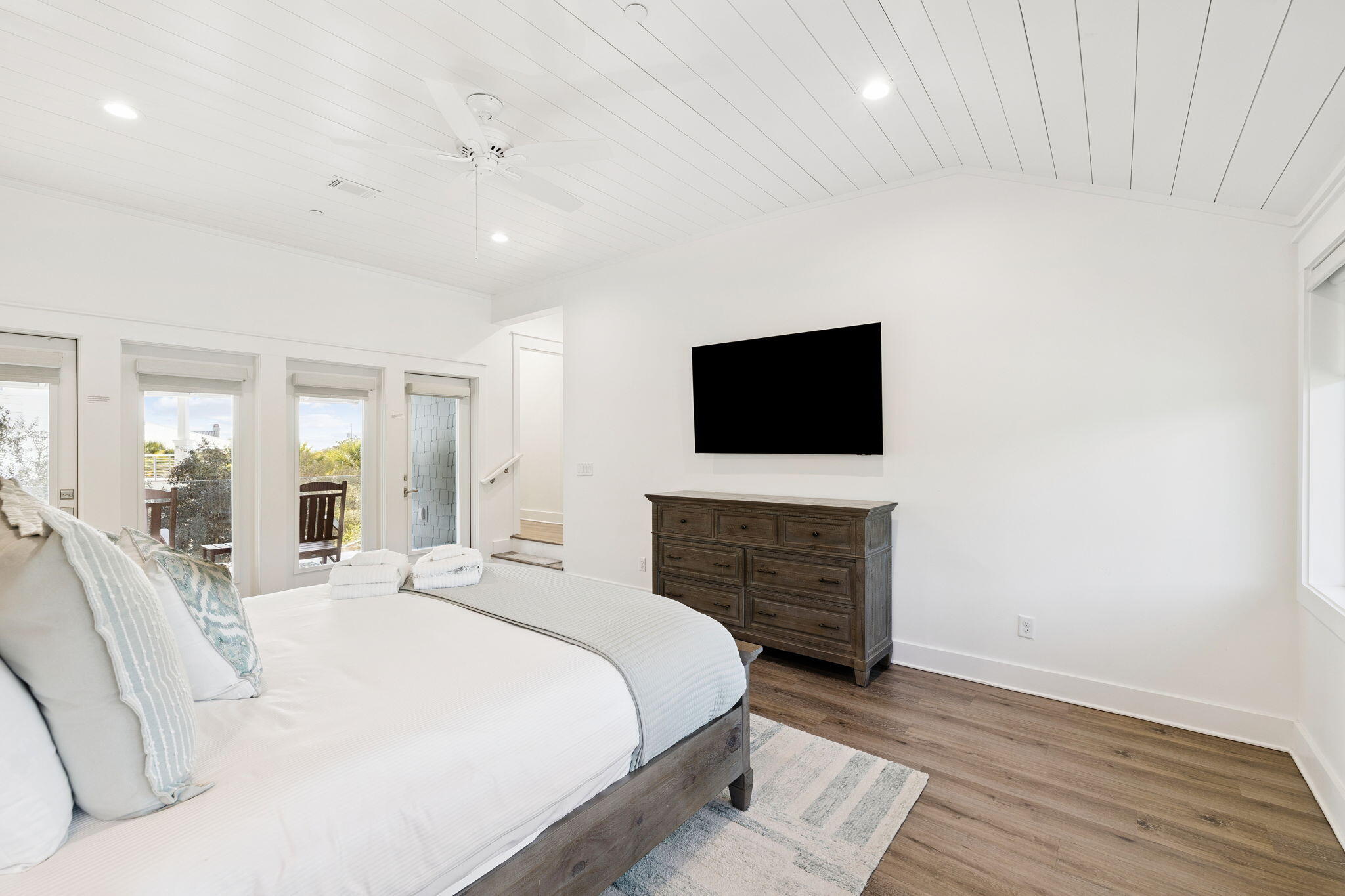 230 Blue Lake Road Santa Rosa Beach, FL 32459 - Photo 66 of 110 a spacious bedroom with a bed and a flat screen tv