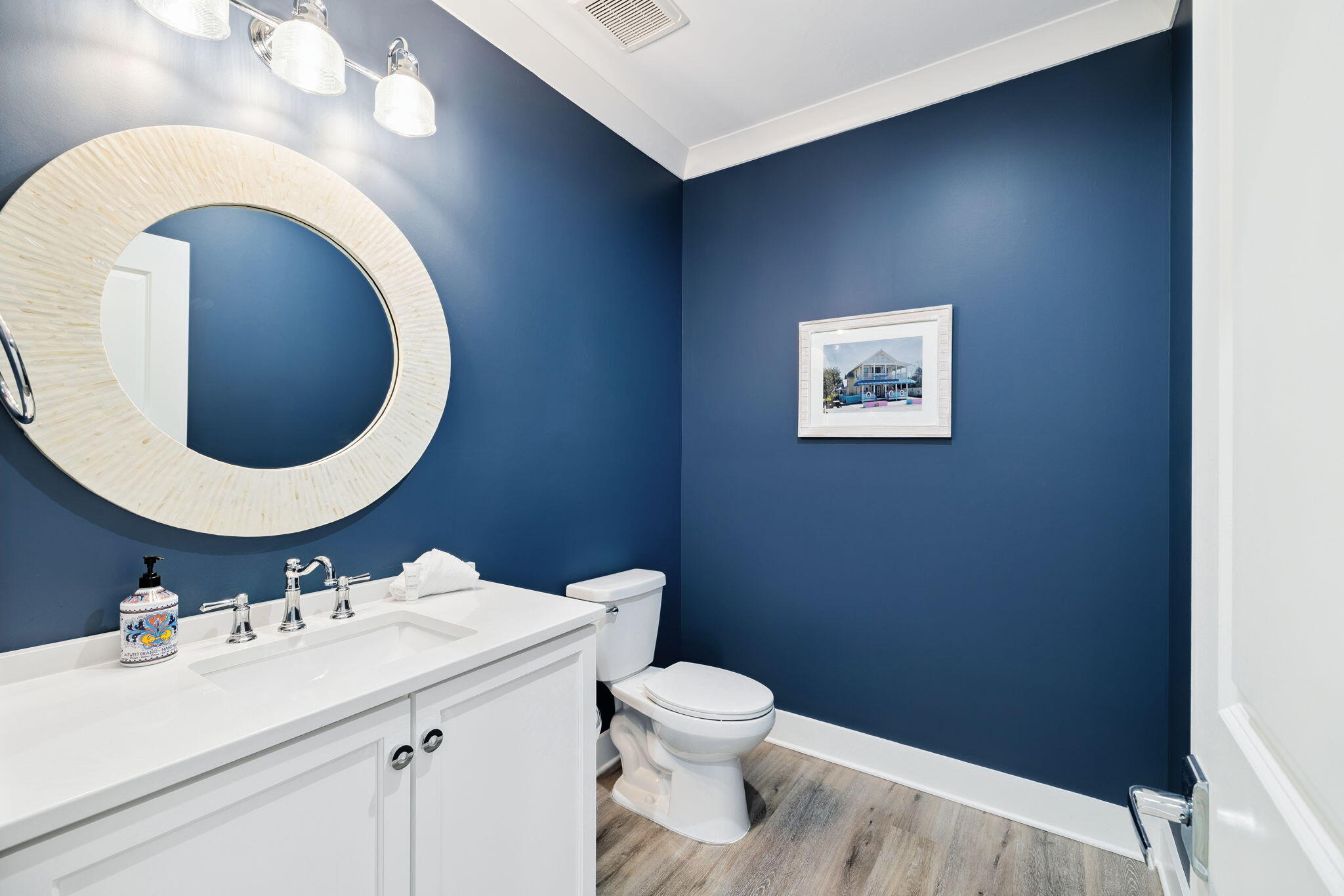 230 Blue Lake Road Santa Rosa Beach, FL 32459 - Photo 72 of 110 a bathroom with a sink mirror vanity and toilet