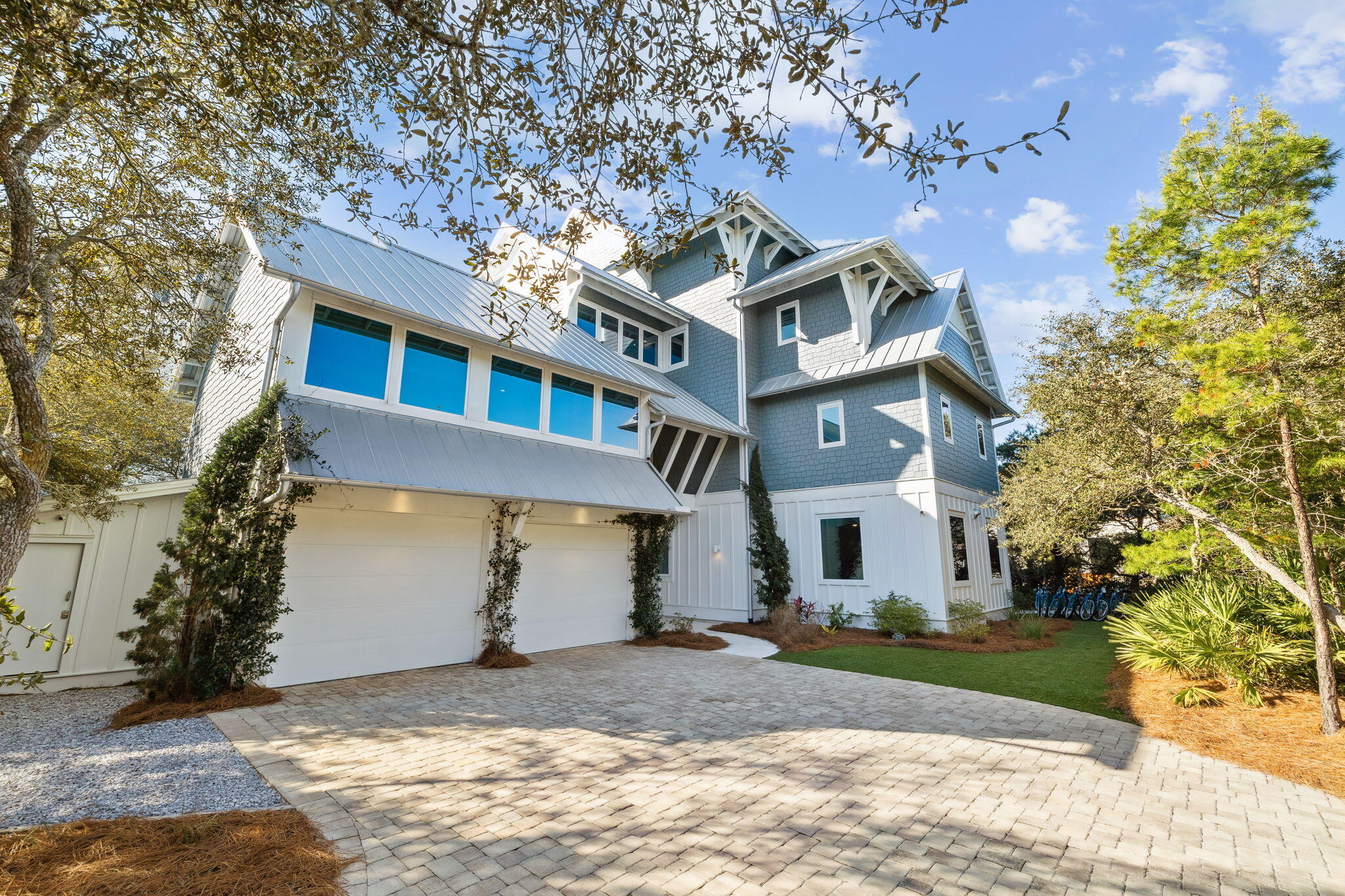 230 Blue Lake Road Santa Rosa Beach, FL 32459 - Photo 8 of 110 a view of a white house next to a yard with large trees