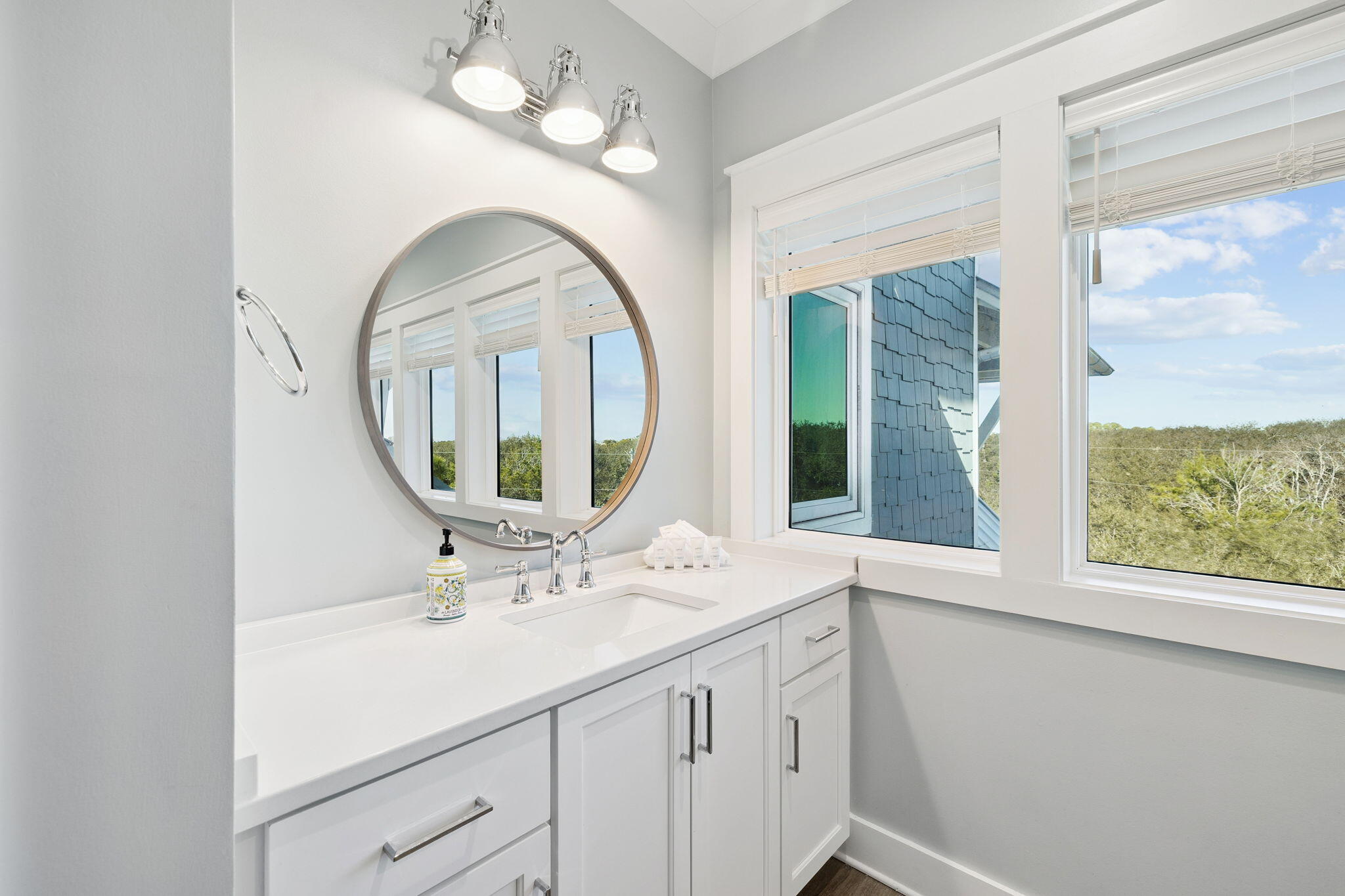 230 Blue Lake Road Santa Rosa Beach, FL 32459 - Photo 91 of 110 a bathroom with a sink and a mirror