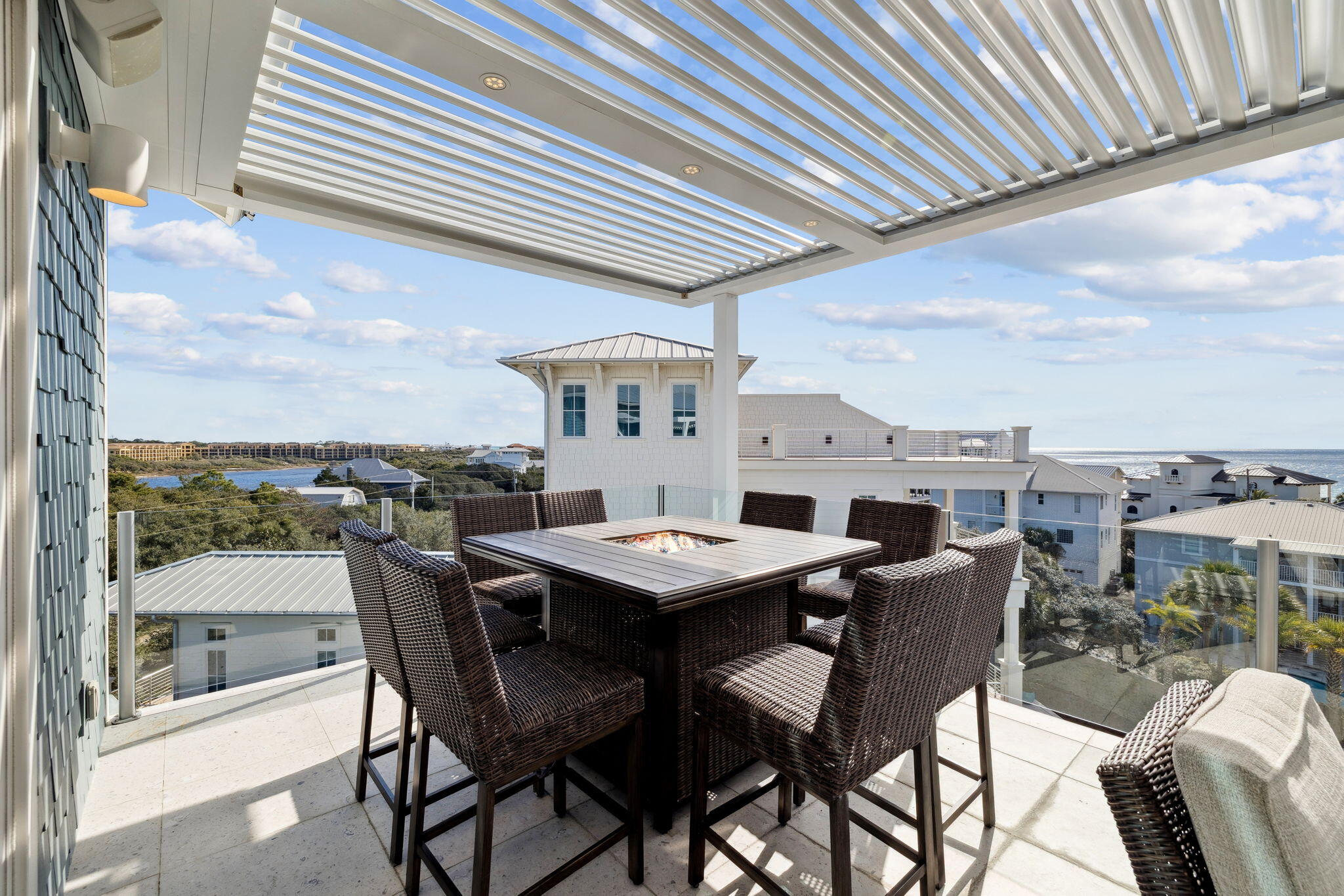 230 Blue Lake Road Santa Rosa Beach, FL 32459 - Photo 100 of 110 a roof deck with a dining table and chairs with wooden floor