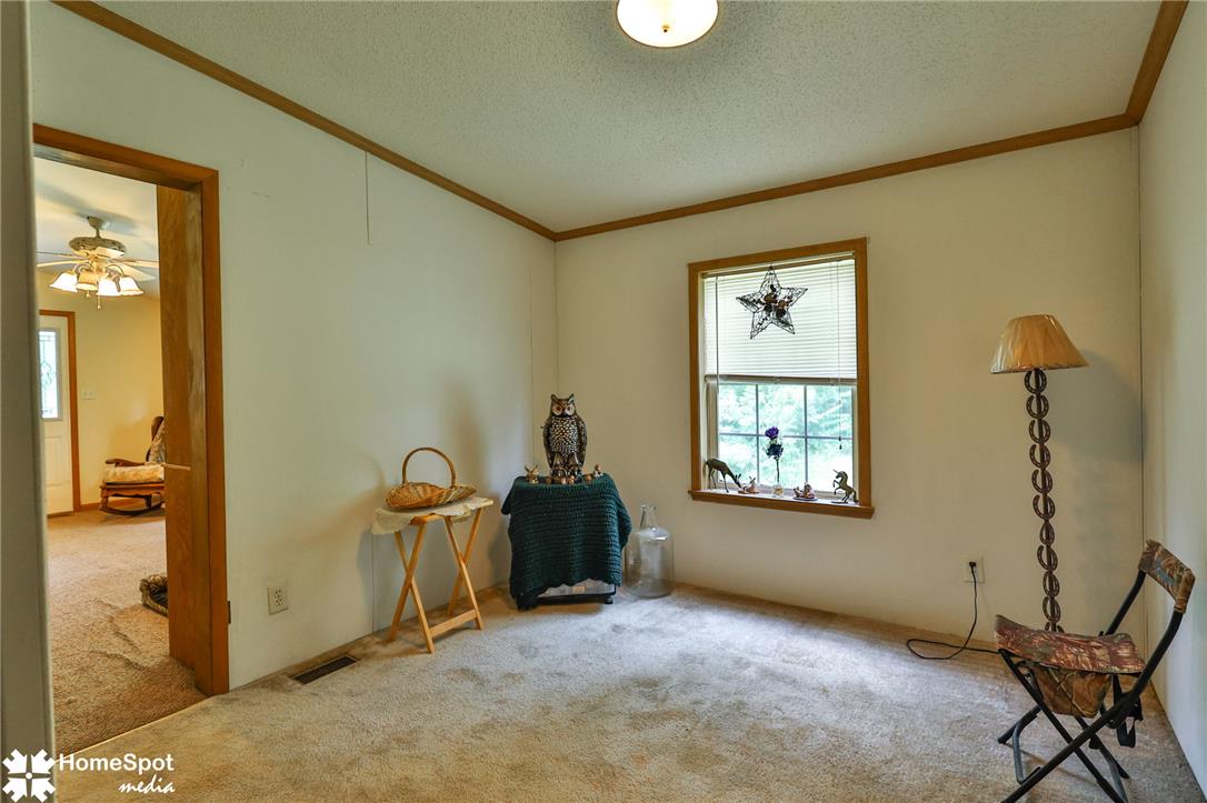 3795 Rhoades Road Kempton, PA 19529 - Photo 18 of 42 A quiet, carpeted room with a single window offering a pleasant outdoor view, ideal for relaxation.