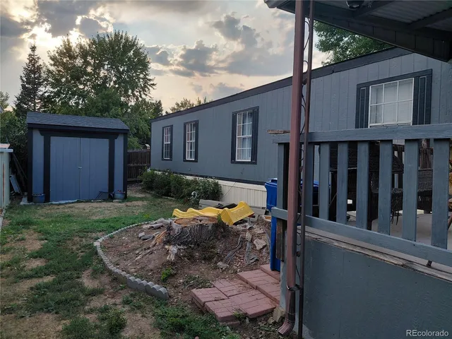 a view of a house with backyard and sitting area