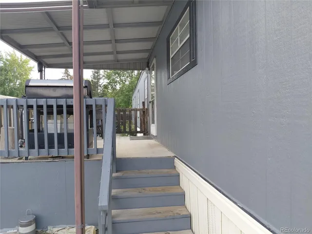 a view of a porch with wooden floor and stairs