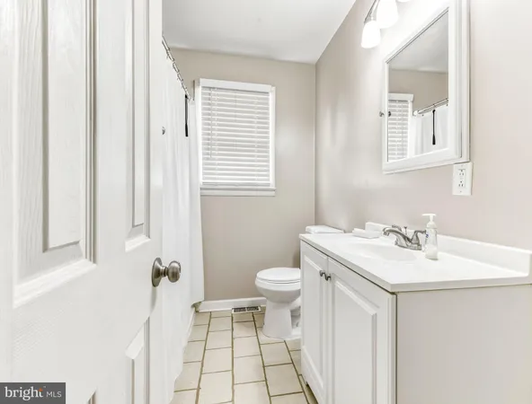 a bathroom with a sink toilet and mirror