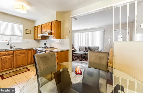 a living room with furniture a dining table and a window