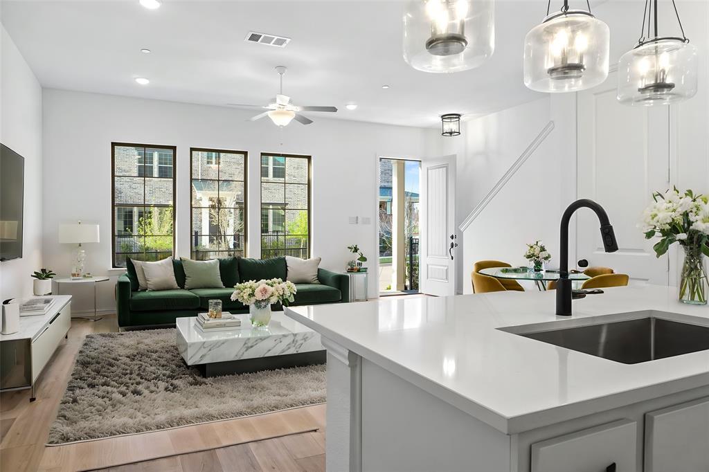 a living room with furniture and chandelier