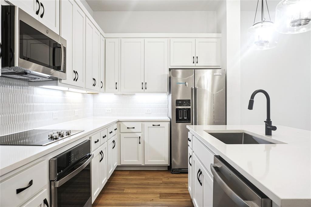 630 Blue Rdg Drive Mansfield, TX 76063 - Photo 10 of 27 a kitchen with stainless steel appliances granite countertop a sink stove and refrigerator