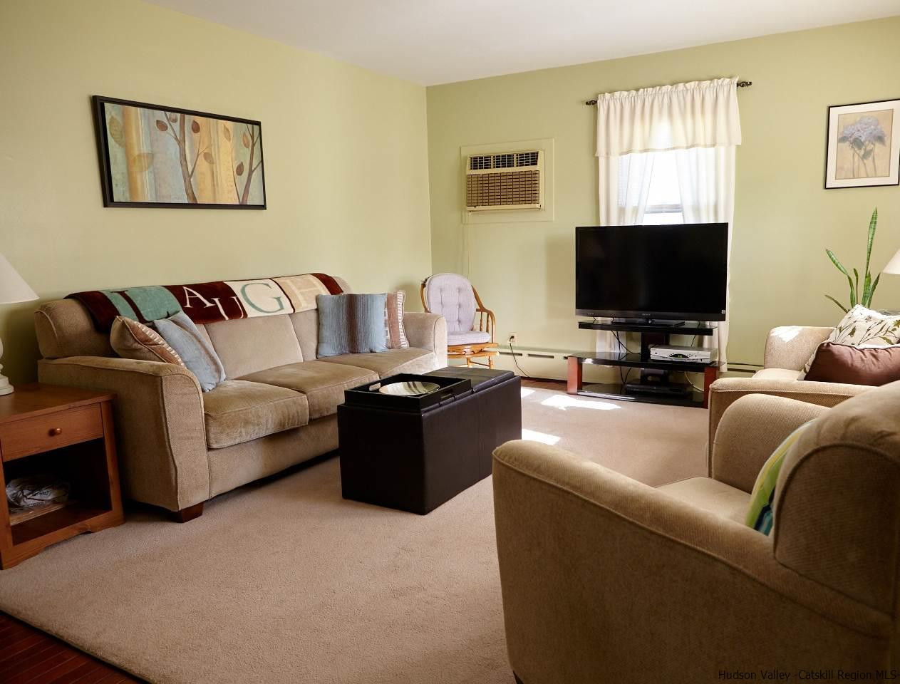 104 South Riverside Road Highland, NY 12528 - Photo 5 of 28 a living room with furniture and a flat screen tv