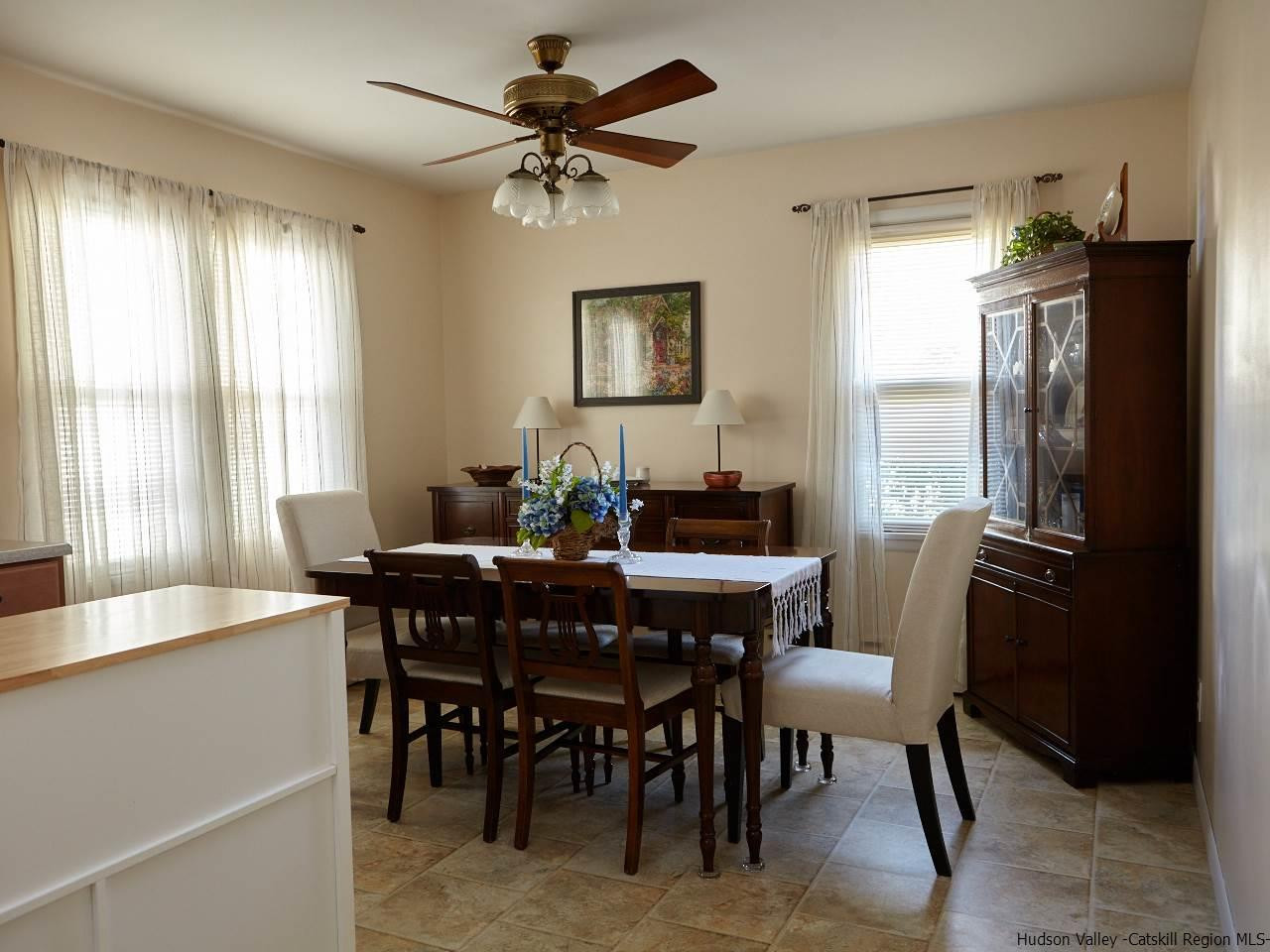 104 South Riverside Road Highland, NY 12528 - Photo 10 of 28 a dining room with furniture a chandelier and window