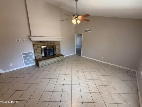 a view of an empty room with a fireplace
