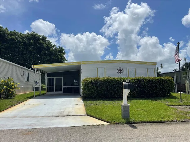 a front view of a house with a garden and plants